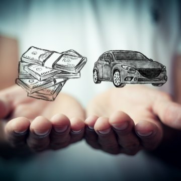 car insurance root insurance holding dollar bills and car in hands 